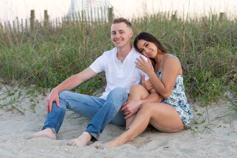 Jake and Diana, the owners of J & D Cleaning, sitting together and smiling