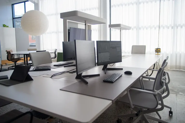 Bright, open office workspace with desks and large windows